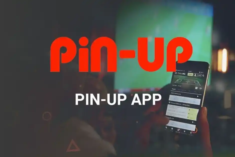 Hand holding phone with sports betting app open, background shows a large screen.